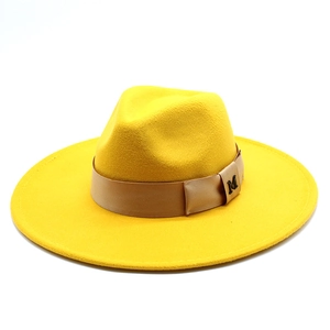 Detailed macro view of the textured yellow wool felt fabric and M-logo satin ribbon