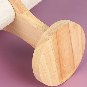 Solid wood jewelry stand with round base and cream fabric cushion for watch display