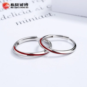 Close-up of S925 sterling silver couple rings with red enamel line and open design