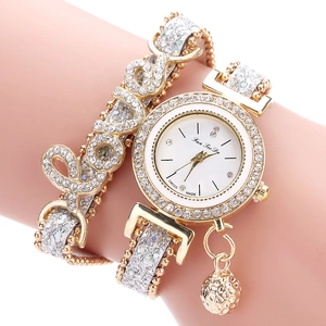 Elegant gold women's wrap bracelet watch with rhinestone LOVE lettering and ball pendant.