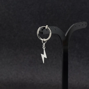 Minimalist silver stainless steel lightning bolt dangle earrings on black jewelry stand
