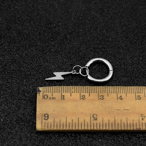 Unisex stainless steel lightning bolt pendant hoop earrings on a black background