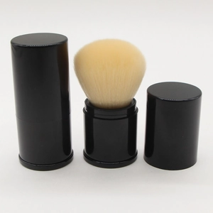 Detail view of a retractable makeup brush with black shell and beige bristles