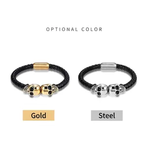 Braided black leather men's bracelet with metal skulls and magnetic clasps in gold and steel