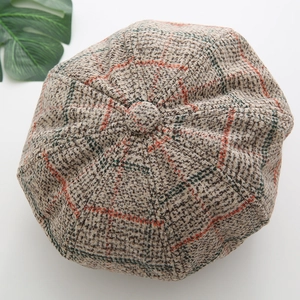 Top view of brown plaid newsboy cap showing detailed wool texture and retro pattern
