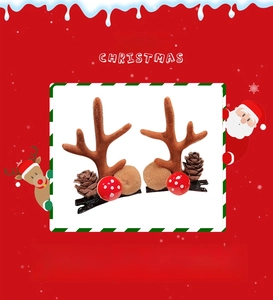 Detailed view of Christmas deer antler hair clips with pine cones and plush mushroom