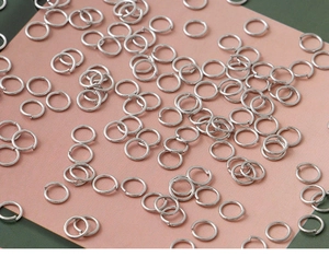 Detailed view of bulk silver-plated open jump rings for DIY jewelry making and crafts