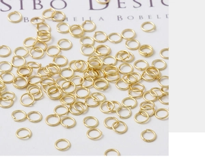 Close-up of golden 18K plated open jump rings for DIY jewelry making and link crafting