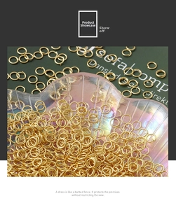 Macro shot of 18K gold-plated jump rings for DIY jewelry making on a shell tray