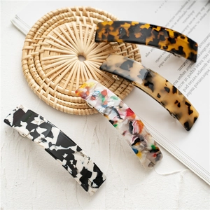 Detailed set of four French acetate hair clips featuring various tortoiseshell patterns
