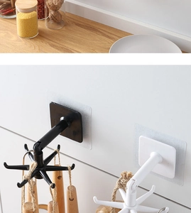 Detail of 360-degree rotating kitchen hooks showing black and white retractable wall mounts