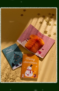 Detailed 3D pop-up Christmas cards with snowman, Santa, and tree designs on warm background