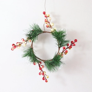 Artificial Christmas wreath featuring green pine needles and red white berry branches