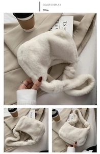 Detail showing plush white faux fur shoulder bag with soft texture and curved design