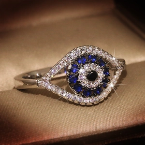 Classic S925 sterling silver evil eye ring with blue and black crystals in a jewelry box