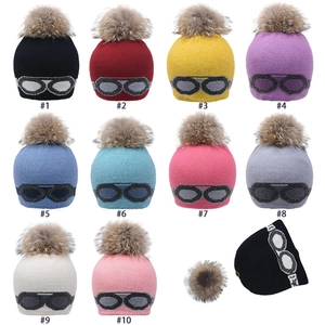 Bonnet d'hiver en maille avec pompon en fausse fourrure et motif lunettes coloré