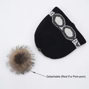 Bonnet en tricot noir avec motif lunettes de ski et pompon en fourrure de râteau amovible