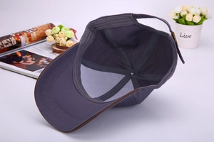 Internal view of the purple grey baseball cap showing stitching and brown brim trim