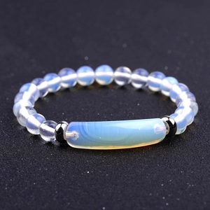 Detailed view of iridescent opalite beads and central curved stone on beaded bracelet