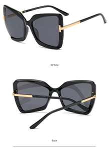 Detail view of butterfly sunglasses showing gold T-hinge and sleek black temples