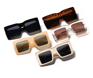 Flat lay of oversized square sunglasses in black, tortoiseshell, tea, pink and cream