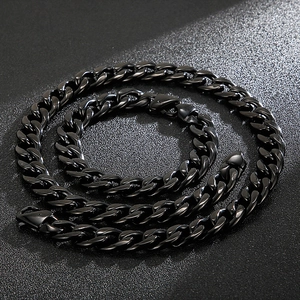 Detail of a black punk-style Cuban link chain necklace with polished metal finish