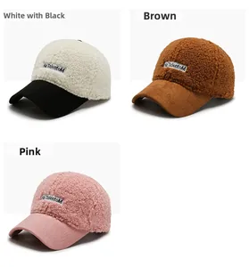 Detail view of winter faux shearling baseball caps in white, brown, and pink colors
