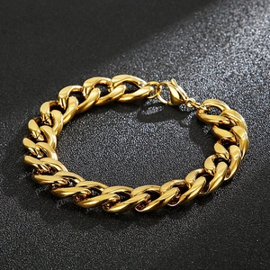 Detailed close-up of golden polished Cuban link bracelet with a secure lobster clasp