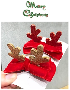 Close-up of Christmas reindeer antler hair clips with red velvet bows and glitter finish