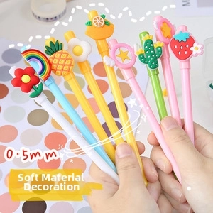 Close-up of cute cartoon 0.5mm gel pens with soft rubber fruit and flower toppers