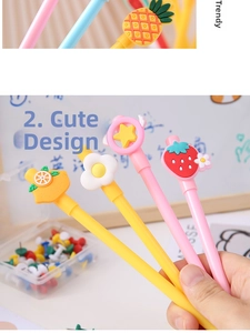 Close-up of cute cartoon gel pens with decorative lemon, flower, star, and strawberry toppers