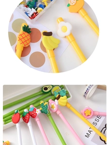 Close-up of cute cartoon-themed neutral pens featuring pineapple and dinosaur designs