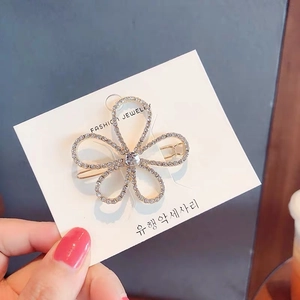 Elegant Korean style floral hair clip with white crystals on a gold alloy base