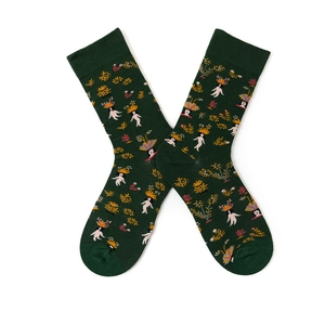 Detail view of cotton mid-calf socks with plant patterns and character illustrations