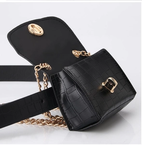 Detail view of mini black faux crocodile belt bag with gold twist lock and chain