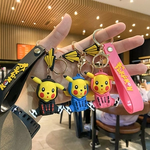 Three Pikachu keychains in black, pink, and blue with PVC straps and metal ring details