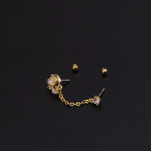 Golden double piercing chain earrings featuring circular moonstone and sparkling zircons