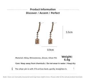 Detail view of crystal geometric drop earrings with 5.5cm length and silver needle studs