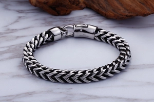 Close-up of 316L stainless steel clasp and silver-black woven leather chain bracelet
