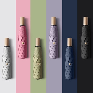 Detailed display of six colorful automatic folding umbrellas with natural wood handles