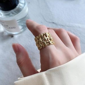Minimalist 925 sterling silver wide woven ring in gold finish on model's hand