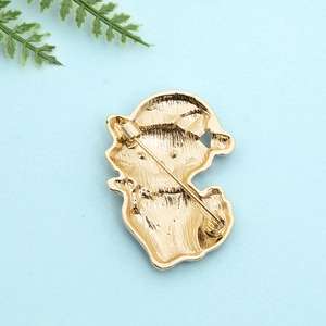 Detailed back view of gold metal cat brooch showing the secure safety pin clasp