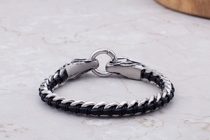 Macro shot of punk style dragon head clasp and black woven leather stainless steel bracelet