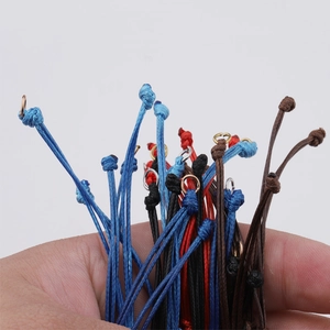 Macro shot of 0.8mm handmade adjustable wax cord bracelets in blue, red, black, and brown