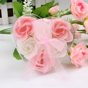 Detail of heart-shaped gift box with six pink and white rose soaps and organza ribbon