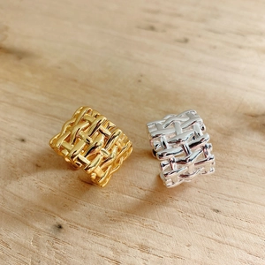 Detailed view of 925 sterling silver braided ring texture in gold and silver finishes