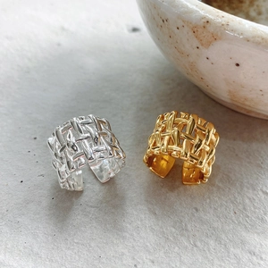 Detailed view of 925 sterling silver braided texture rings in gold and silver finish