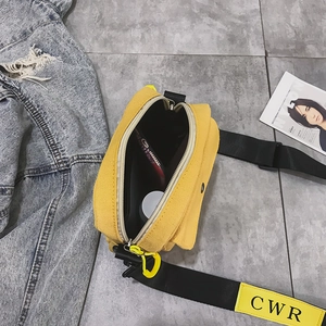 Yellow canvas crossbody bag for women featuring a wide black strap and magnetic front flap