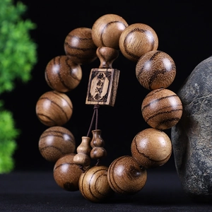 Buddhist mala beads with natural wood grain and carved agarwood plaque decoration