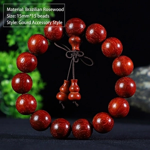 Macro shot of 15mm Brazilian Rosewood prayer beads with wood grain and gourd charm